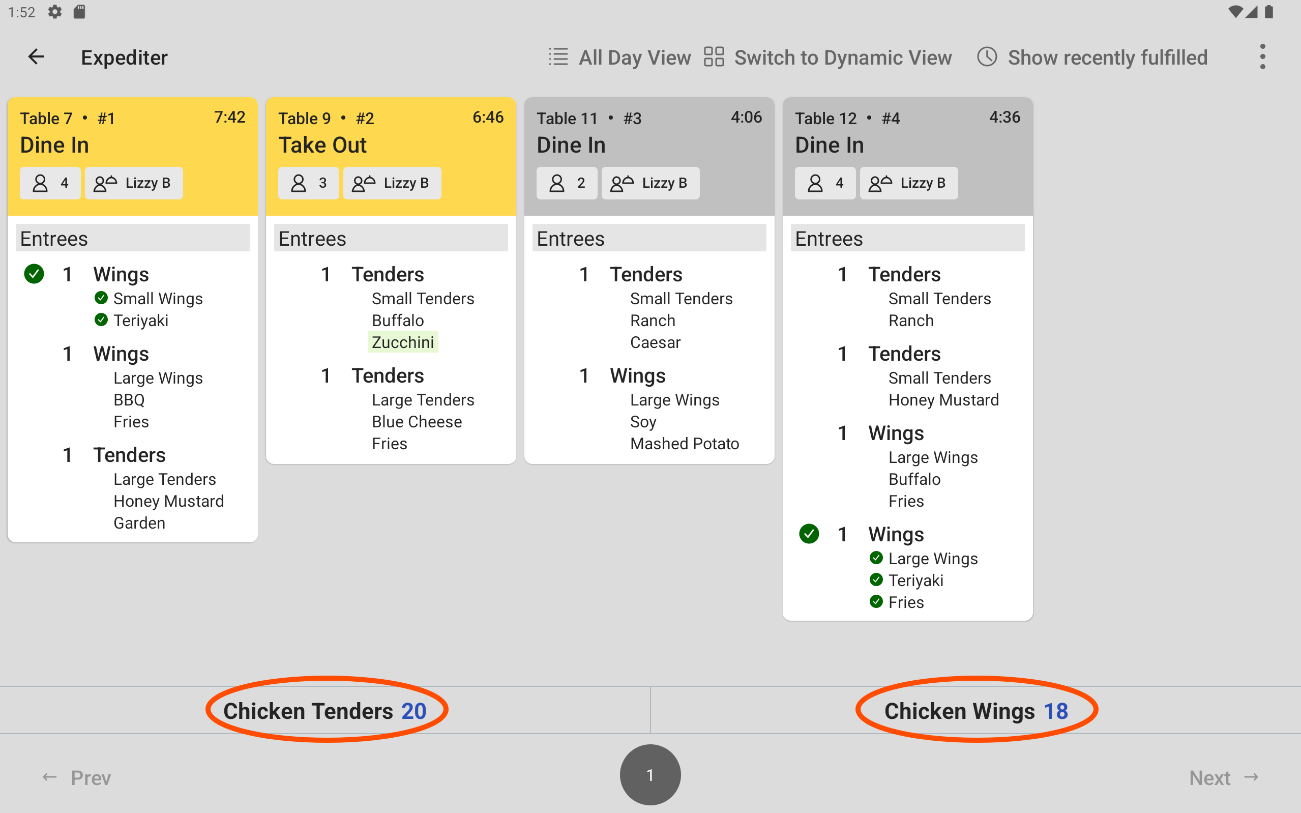 A KDS showing total counts for chicken wings and chicken tenders production items below the order tickets.
